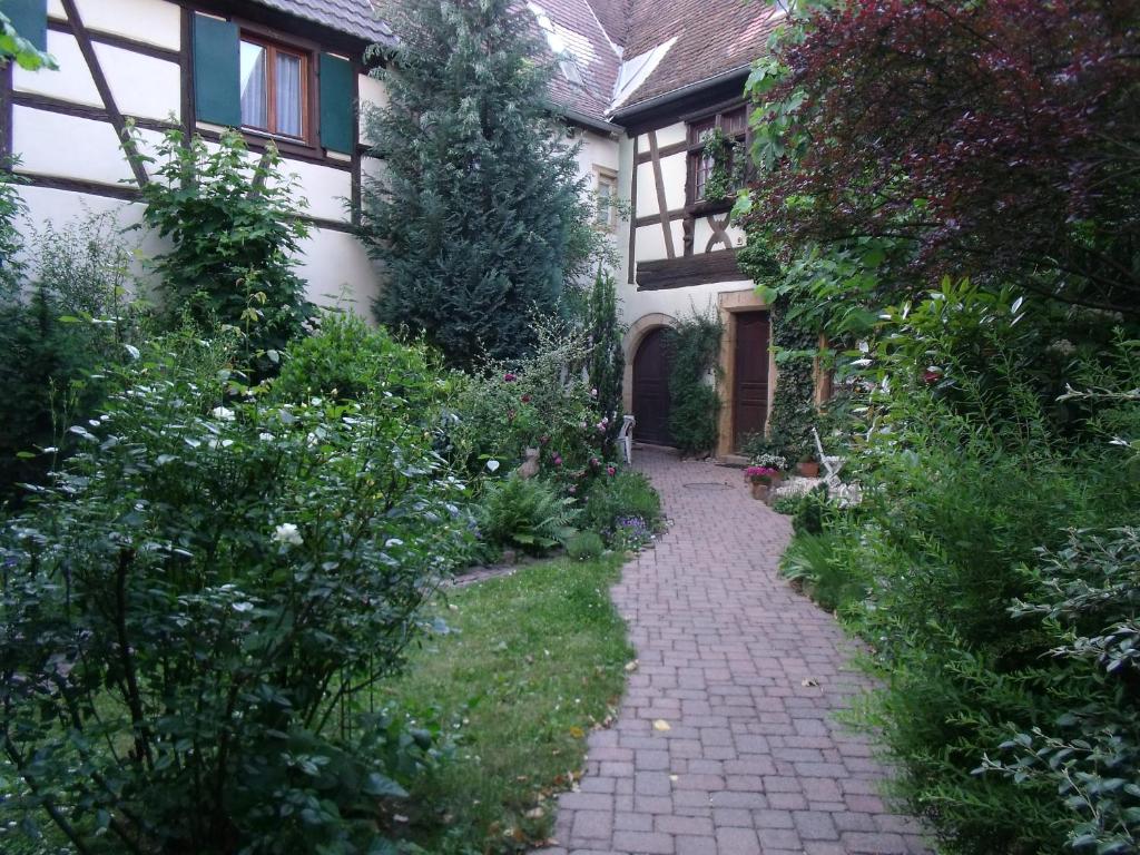 a garden path in front of a house at Apt. La Grenouillère De Turckheim in Turckheim
