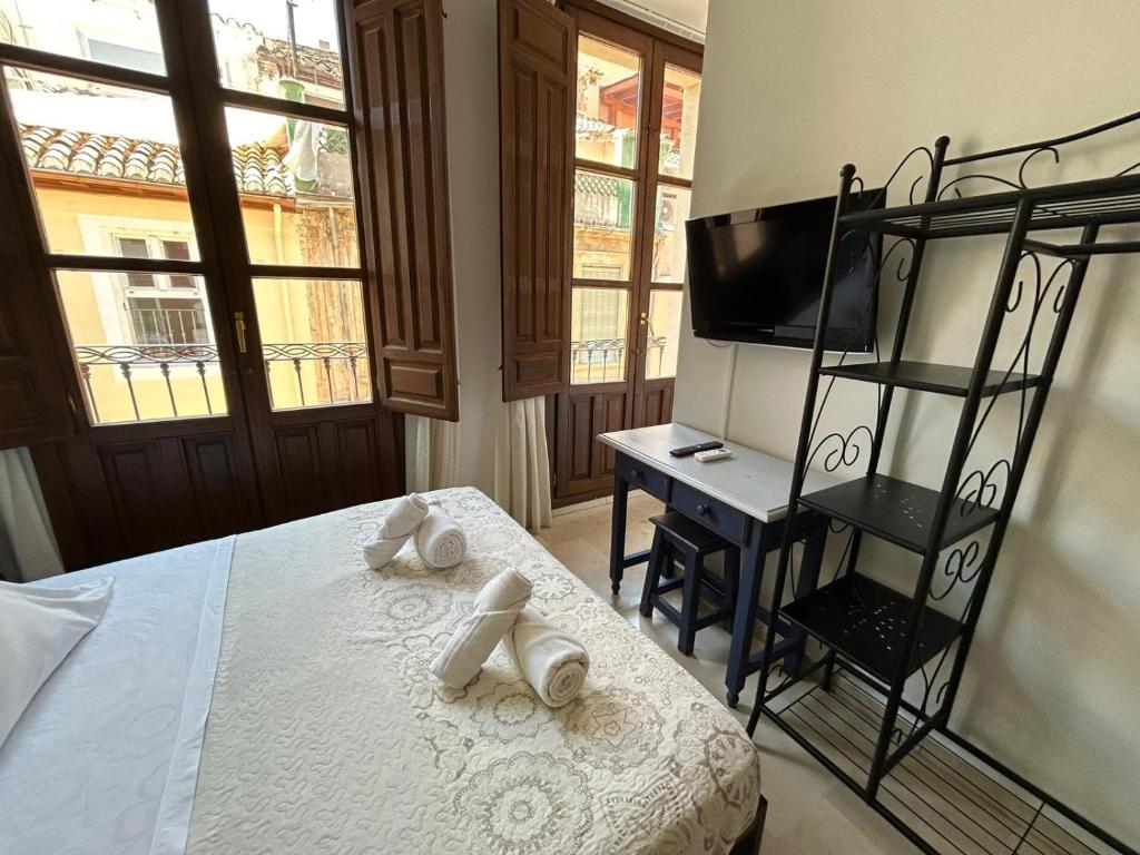 Postel nebo postele na pokoji v ubytování Hostal El Olivo