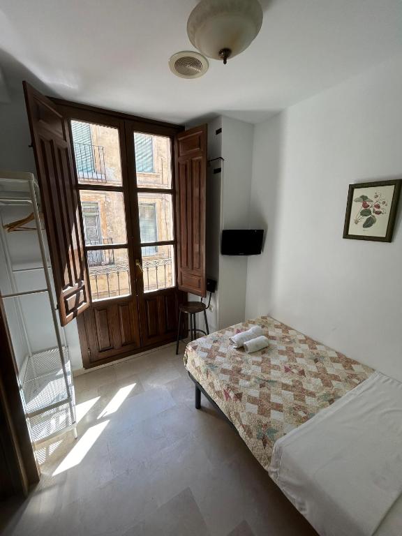 Postel nebo postele na pokoji v ubytování Hostal El Olivo