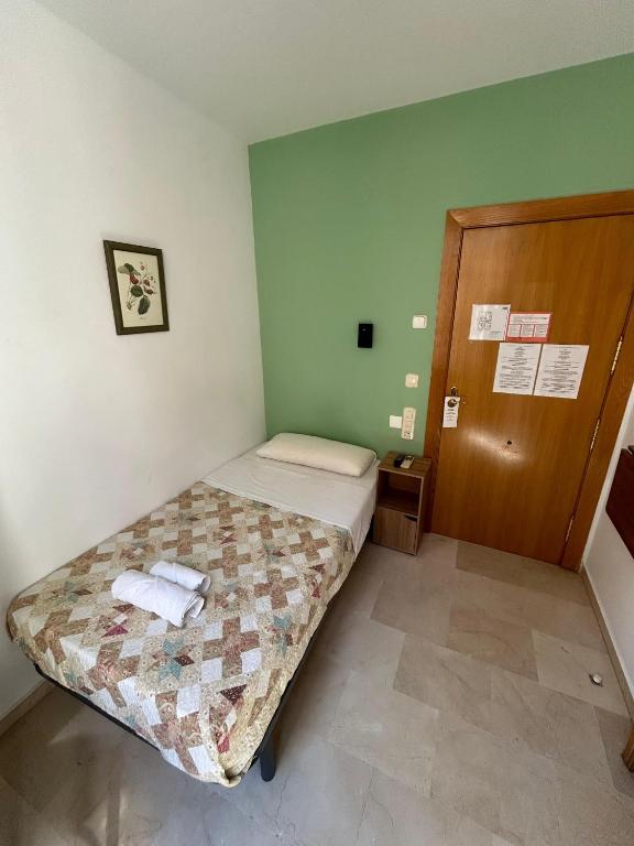 Postel nebo postele na pokoji v ubytování Hostal El Olivo