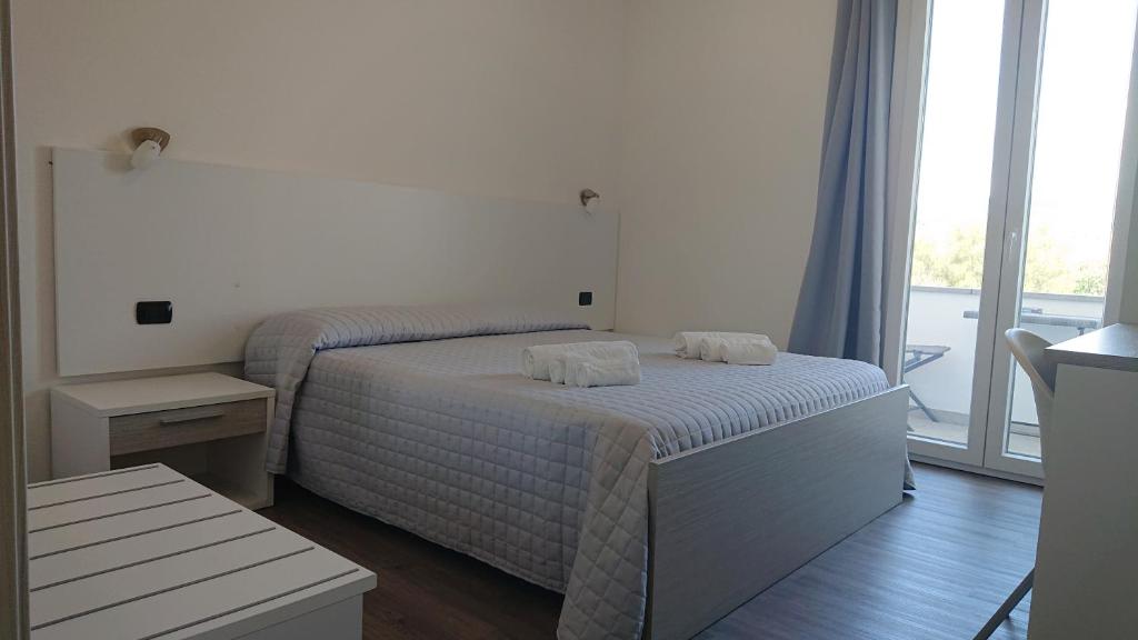 Posteľ alebo postele v izbe v ubytovaní Hotel Ogliastra