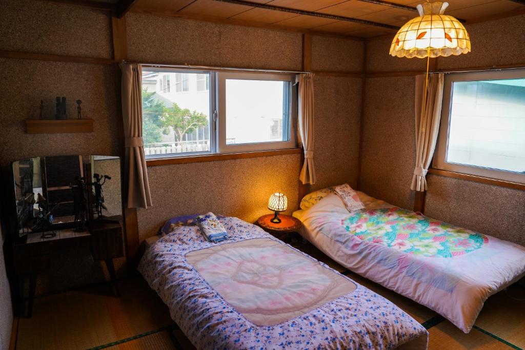 Postel nebo postele na pokoji v ubytování Rishiri Antique Inn
