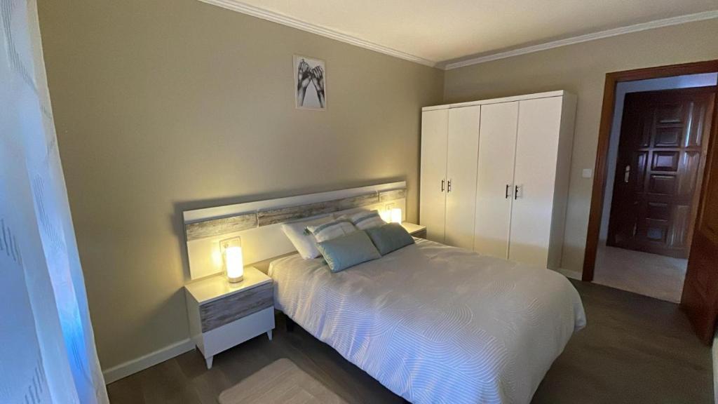 a bedroom with a bed with a light on it at Apartamento A Costa Da Morte in Santa Comba