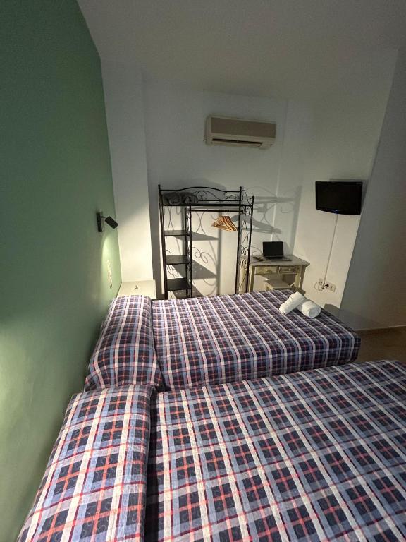 Postel nebo postele na pokoji v ubytování Hostal El Olivo