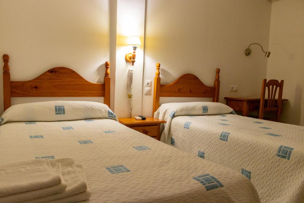 Postel nebo postele na pokoji v ubytování Hotel Philadelfia