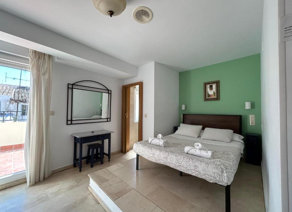 Postel nebo postele na pokoji v ubytování Hostal El Olivo