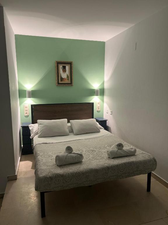 Postel nebo postele na pokoji v ubytování Hostal El Olivo