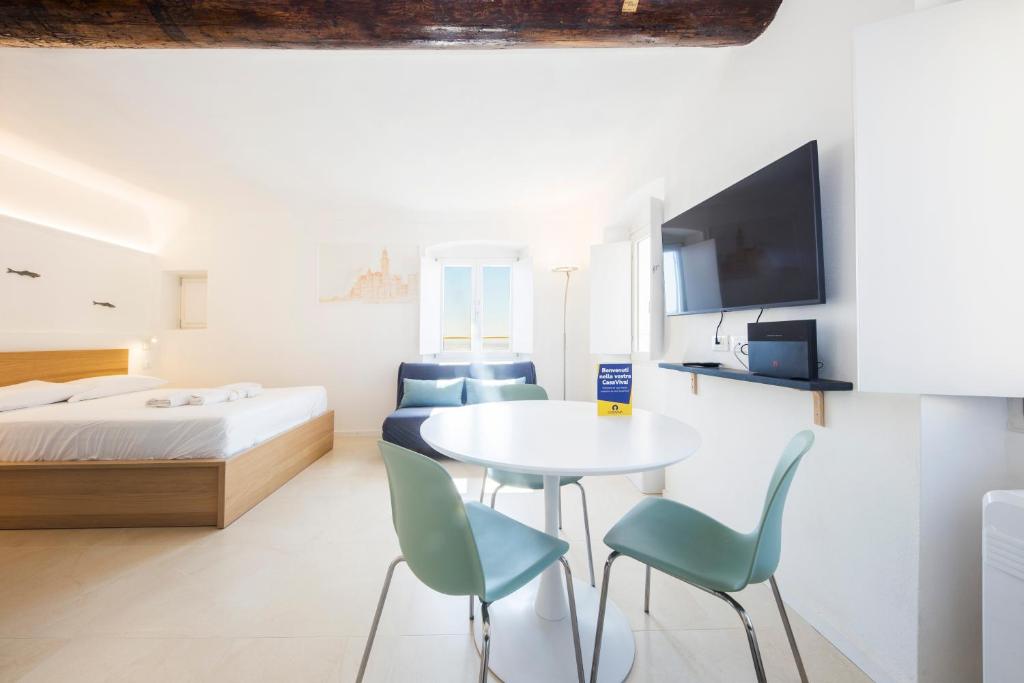 a bedroom with a bed and a table and chairs at CasaViva - Elegant Seaview Studio in Camogli in Camogli