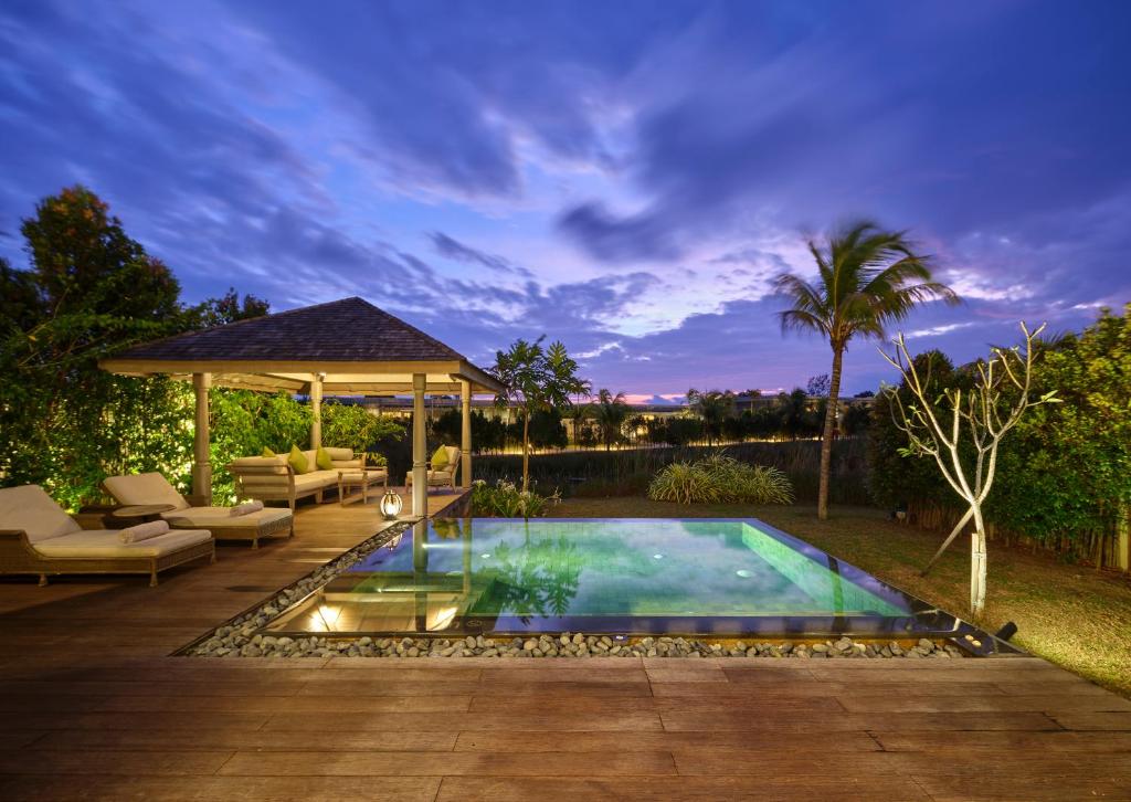 a backyard with a swimming pool and a gazebo at Anantara Desaru Coast Resort & Villas in Desaru