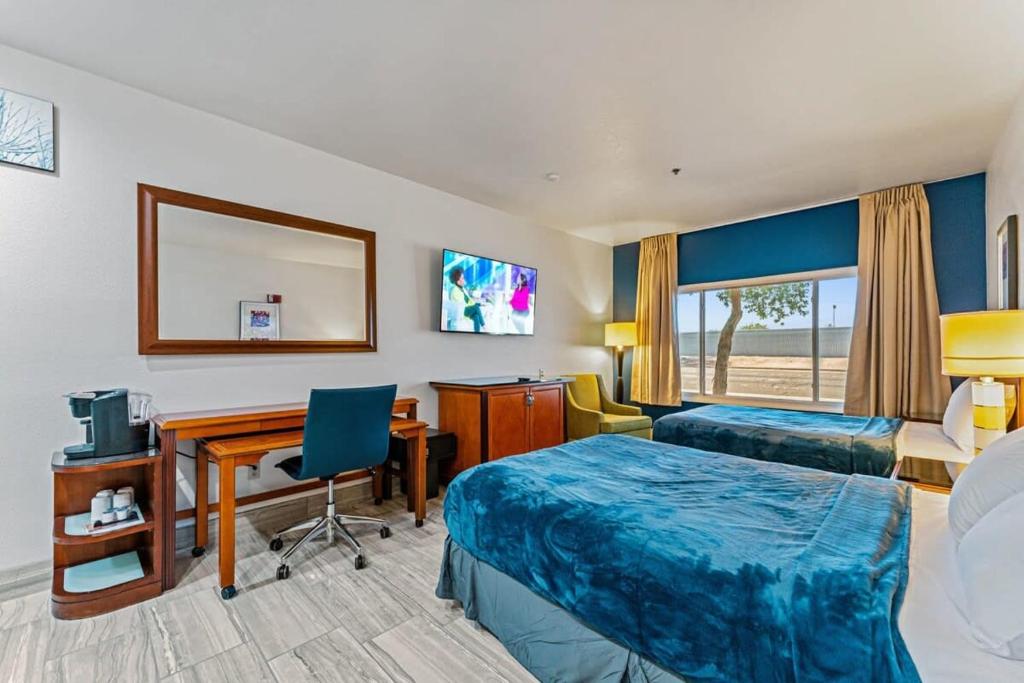 a hotel room with two beds and a desk at Metro Extended Stays - Tempe - 2 Full Beds in Tempe