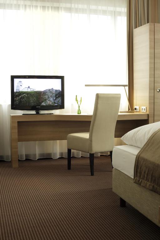 TV a/nebo společenská místnost v ubytování H4 Hotel Berlin Alexanderplatz