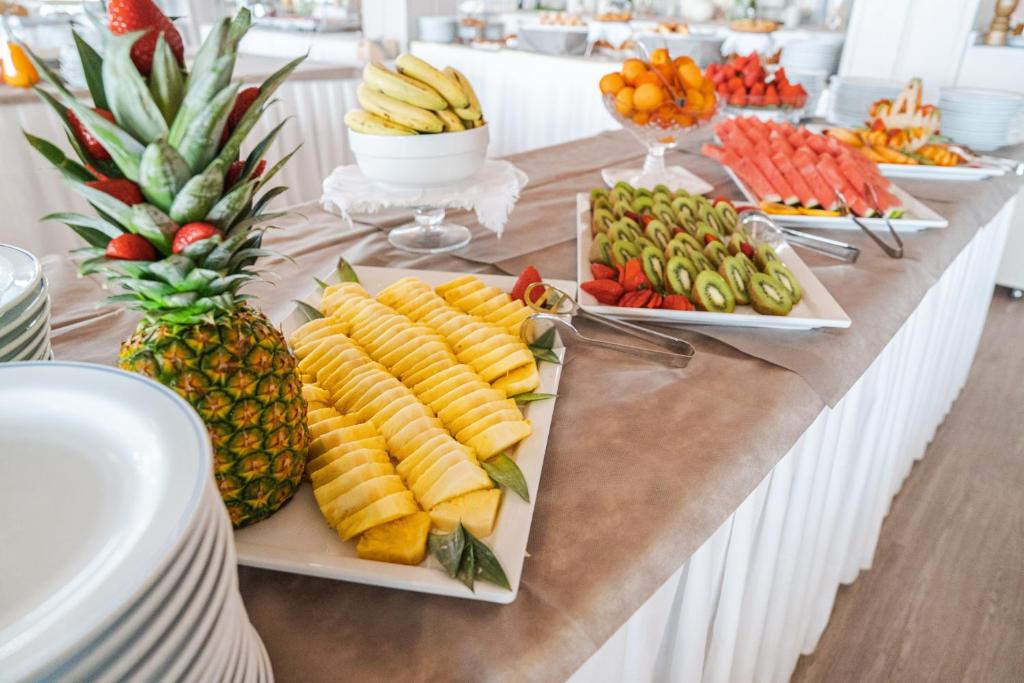 a buffet with fruits and vegetables on a table at Rouge International Resort in Milano Marittima
