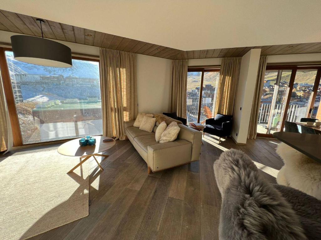 a living room with a couch and a table at Penthouse luxe Tignes Lavachet 4 chambres pour 8 pers. avec terrasse - FR-1-641-72 in Tignes