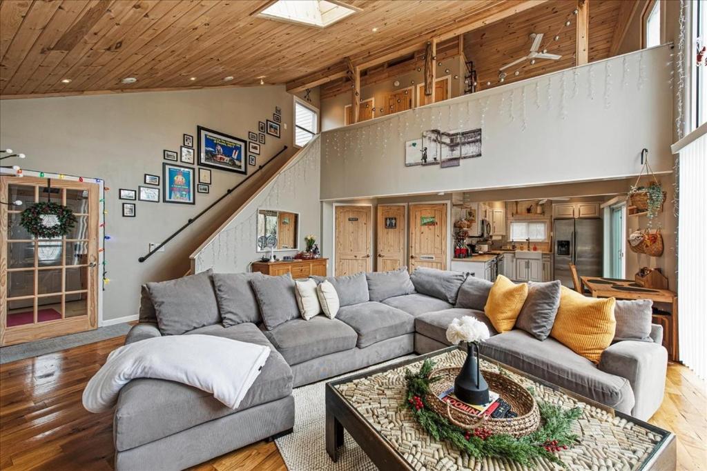 a living room with a couch and a table at Pocono Scandinavian Cottage in Tobyhanna