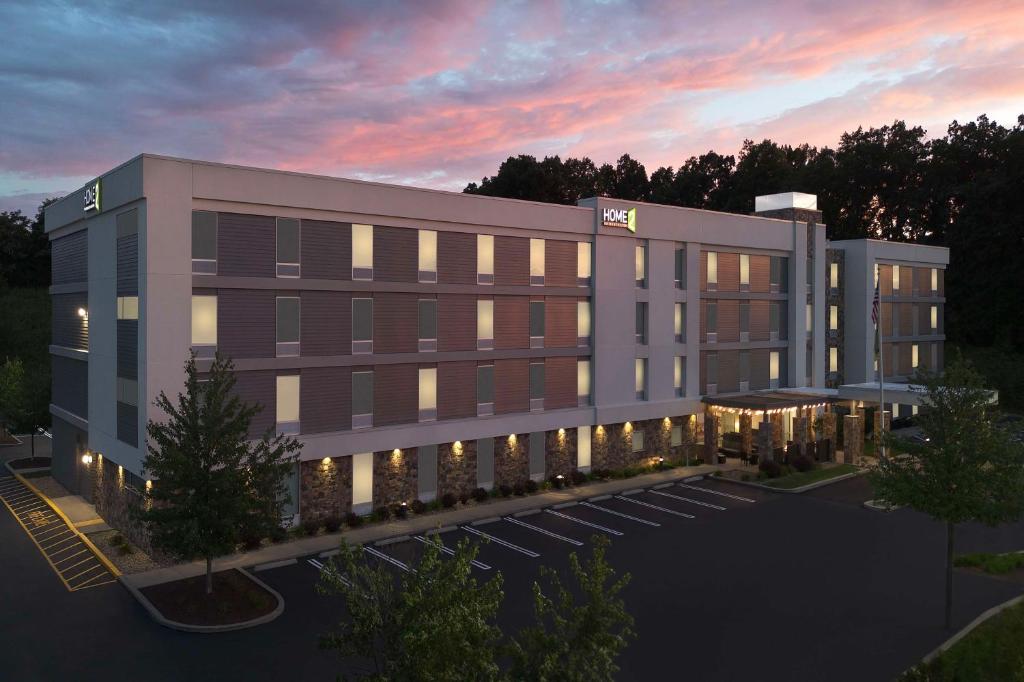 an architectural rendering of a building at dusk at Home2 Suites by Hilton Pittsburgh - McCandless, PA in McCandless Township