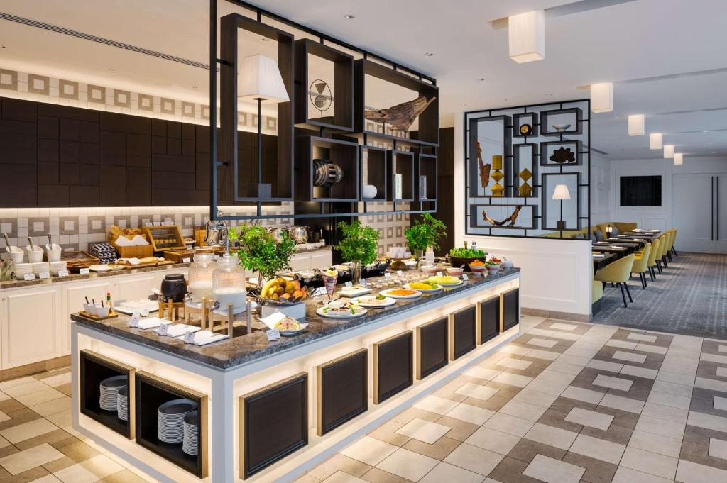 a buffet line in a restaurant with food on it at Hilton Osaka Hotel in Osaka