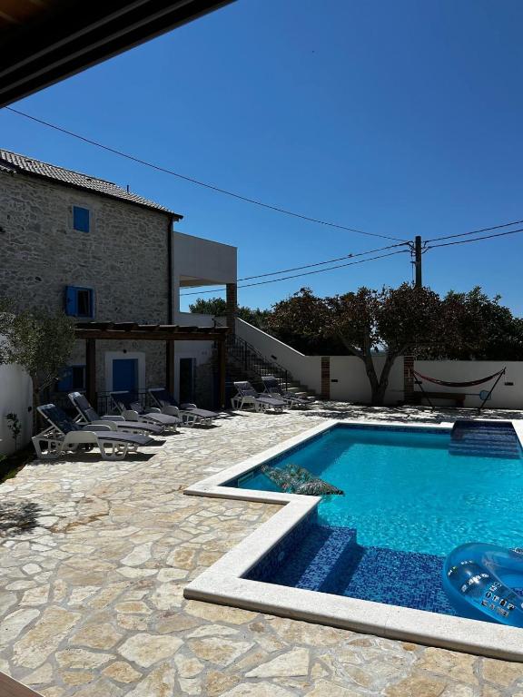 a swimming pool in front of a house at Villa Granda in Visočane