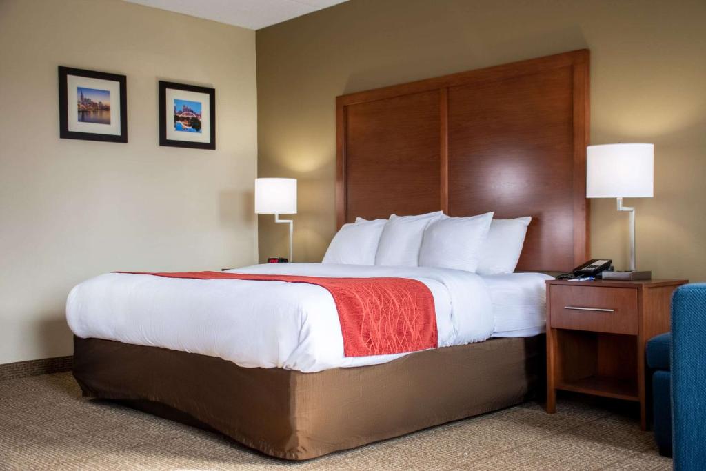 a hotel room with a large bed and a telephone at Comfort Inn in Dickson
