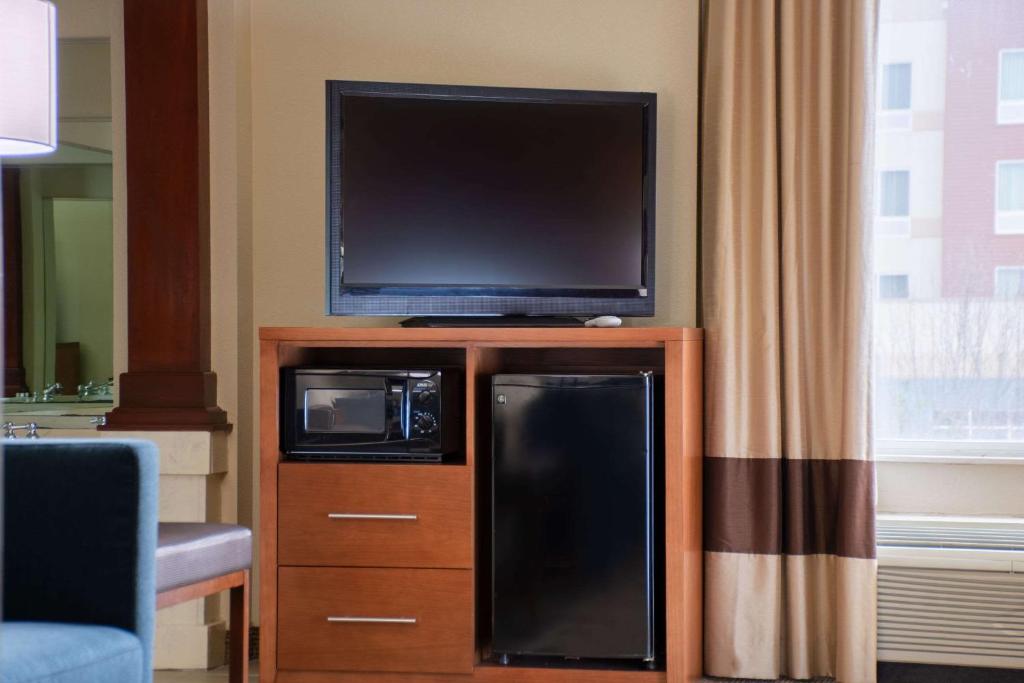 a flat screen tv sitting on top of a entertainment center at Comfort Inn in Dickson
