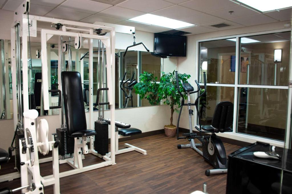 a gym with several treadmills and machines in a room at Comfort Inn in Dickson
