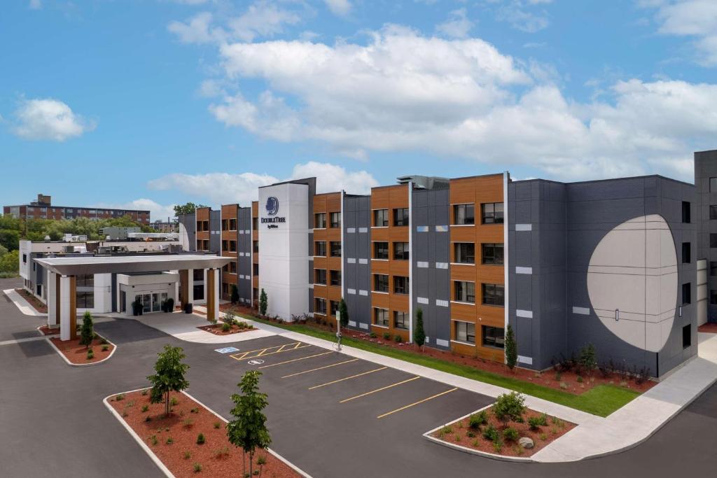 a rendering of an apartment building with a parking lot at DoubleTree by Hilton Kingston - Newly Renovated in Kingston