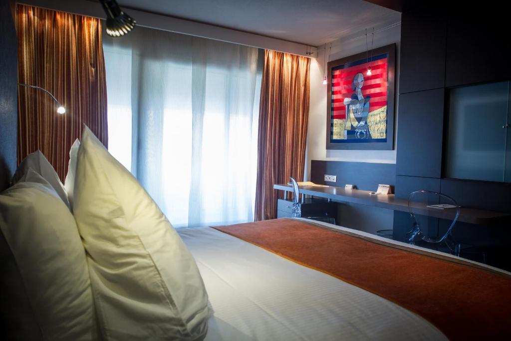 Postel nebo postele na pokoji v ubytování Hôtel & Spa Vatel