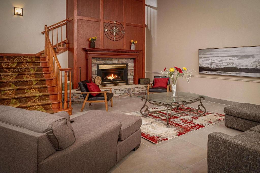 a living room with a couch and a fireplace at Country Inn & Suites by Radisson, Beckley, WV in Beckley