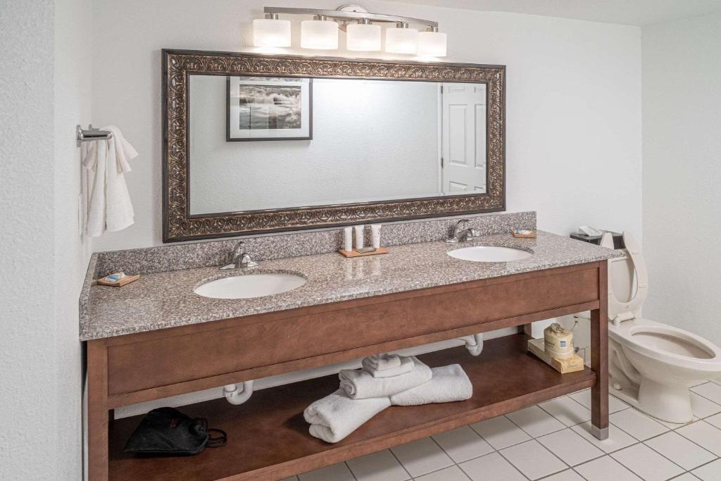 a bathroom with two sinks and a mirror at Country Inn & Suites by Radisson, Beckley, WV in Beckley