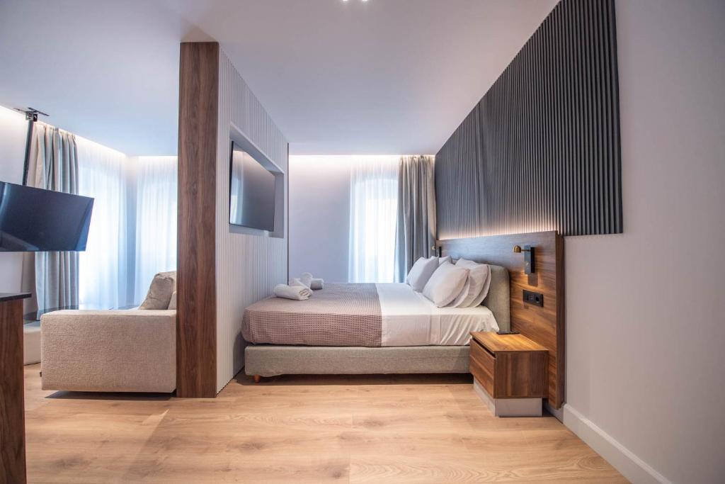 Postel nebo postele na pokoji v ubytování Kantoni Suites