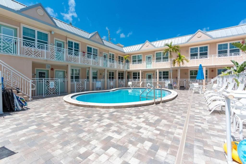 a resort with a swimming pool and a building at Clearwater Beach Suites #106 in Clearwater Beach