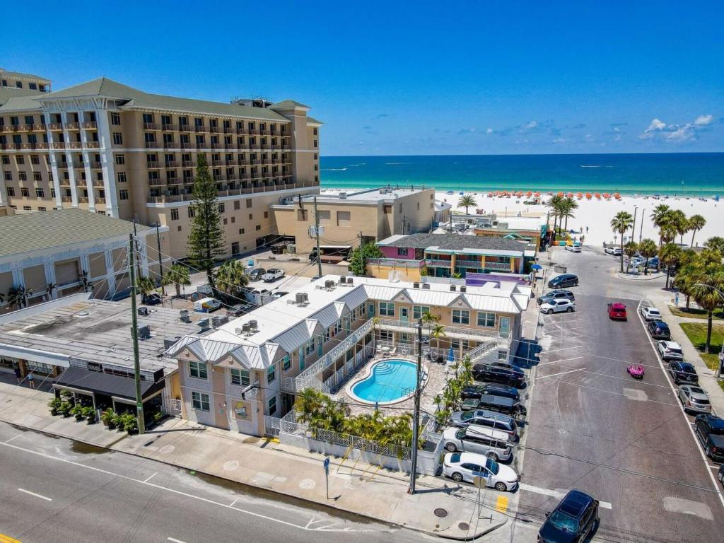 an aerial view of a resort with a pool and the beach at Clearwater Beach Suites #105 in Clearwater Beach