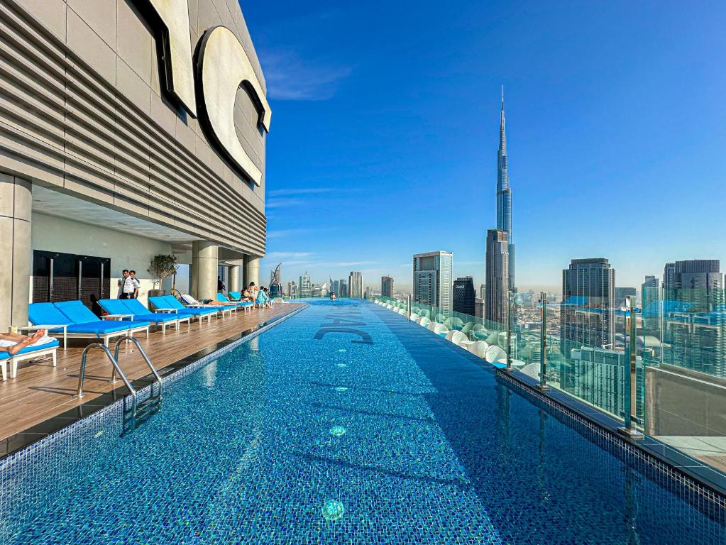 Hotel Sky-high Oasis Burj Khalifa Views, Rooftop Infinity Pool, 3BR apartment in Paramount Hotel Midtown, a swimming pool on top of a building with a city skyline at Sky-high Oasis Burj Khalifa Views, Rooftop Infinity Pool, 3BR apartment in Paramount Hotel Midtown in Dubai