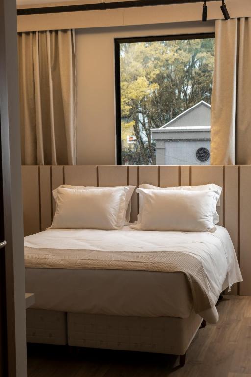 Postel nebo postele na pokoji v ubytování Plaza Hotel & Boulevard Convention - Vale dos Vinhedos