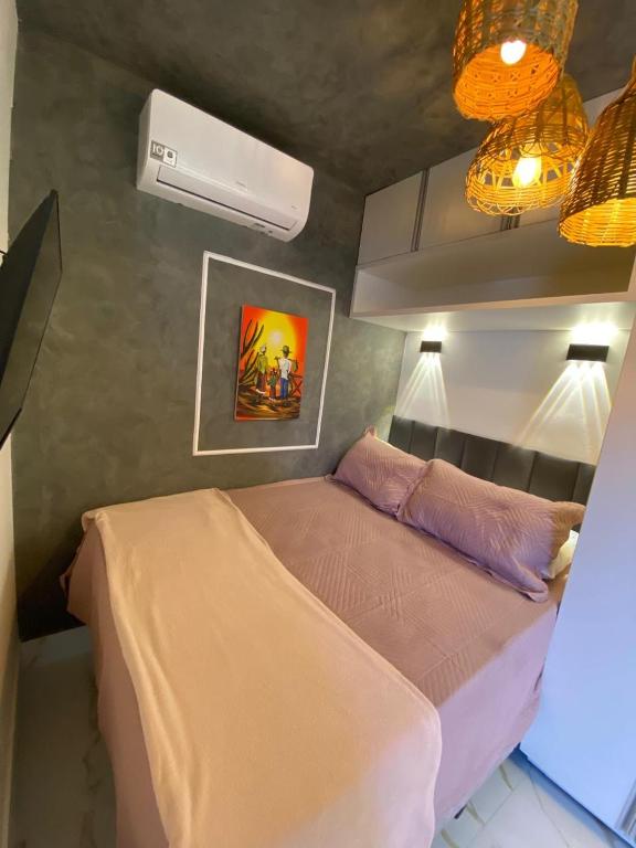a bedroom with a bed and a fan and lights at Casa Essence - loftsparaíso in Luis Eduardo Magalhaes