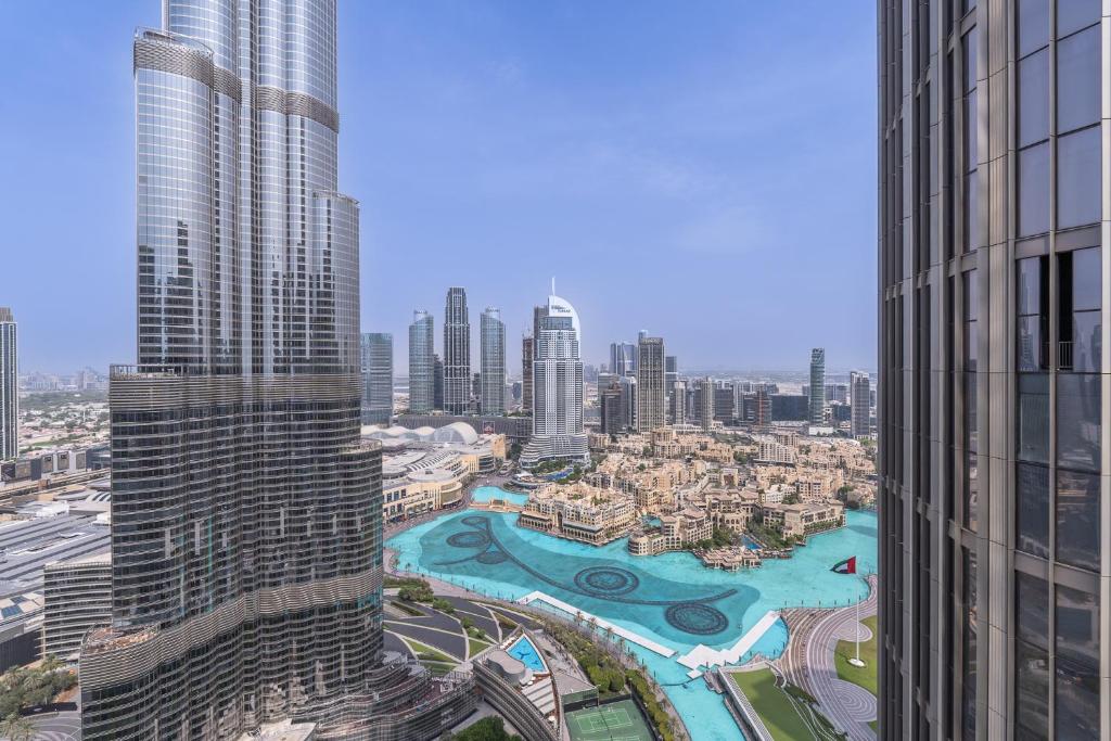 an aerial view of a city with tall buildings at Address Residences Dubai Opera - Burj Khalifa City Views 1, 2, & 3-Bedroom Apartment 1 minute walk to Burj Khalifa, Dubai Mall, Dubai Fountain by Heaven Crest in Dubai