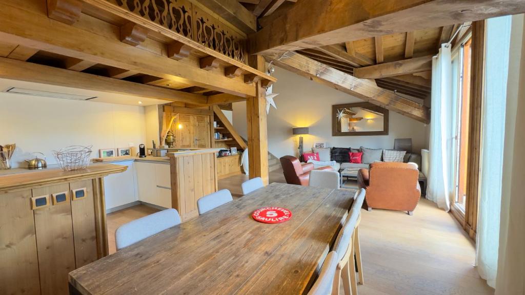 Il comprend une cuisine et un salon avec une table en bois. dans l'établissement Appartement 1004 Grand Sud, à Courchevel