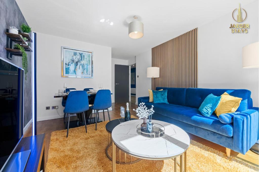 a living room with a blue couch and a table at 2 Bedroom Greek Street Apartment - Sleeps up to 6 in Leeds