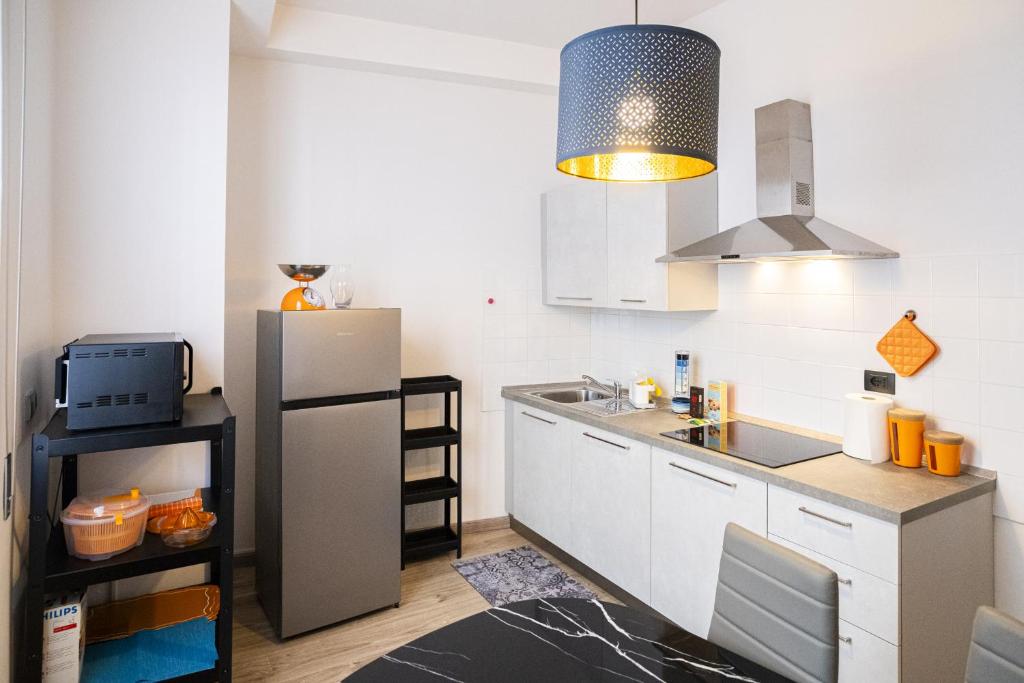 a kitchen with a refrigerator and a sink at Lupo di Mare by Wonderful Italy in Savona