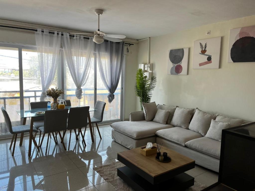 a living room with a couch and a table at Résidence la rosée in Mamoudzou