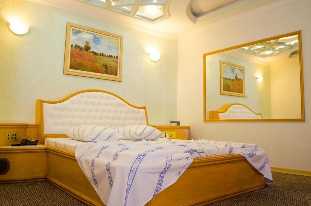 Cama o camas de una habitación en Omega Palace Hotel