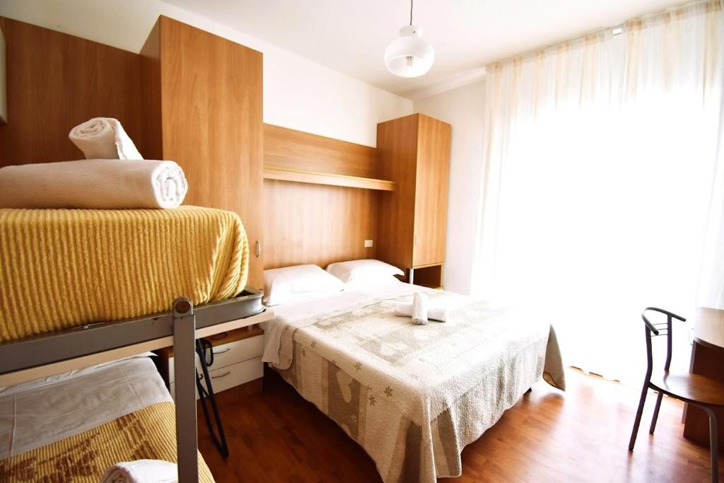 Postel nebo postele na pokoji v ubytování Hotel Galles