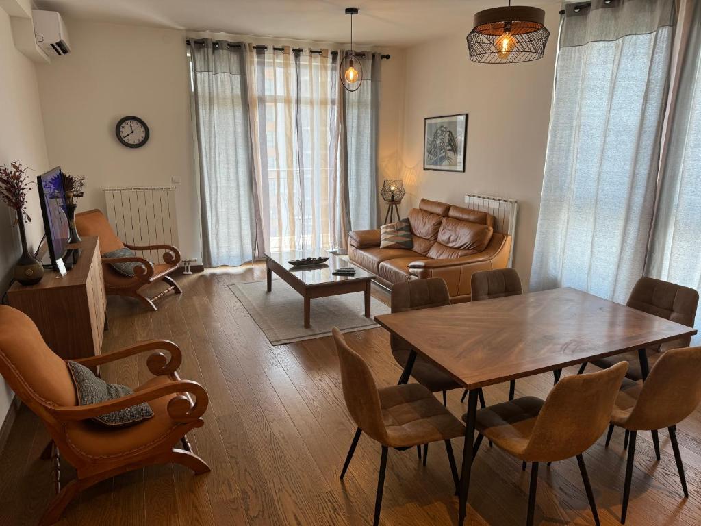 a living room with a table and a couch at BW Arcadia deluxe apartments in Sajmište