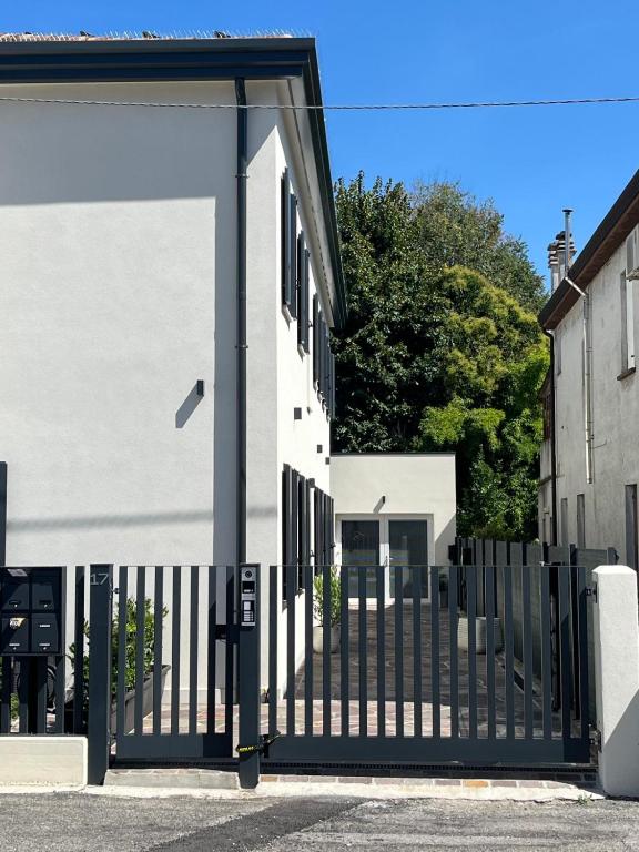 a black gate in front of a white building at House of Flowers in Spinea