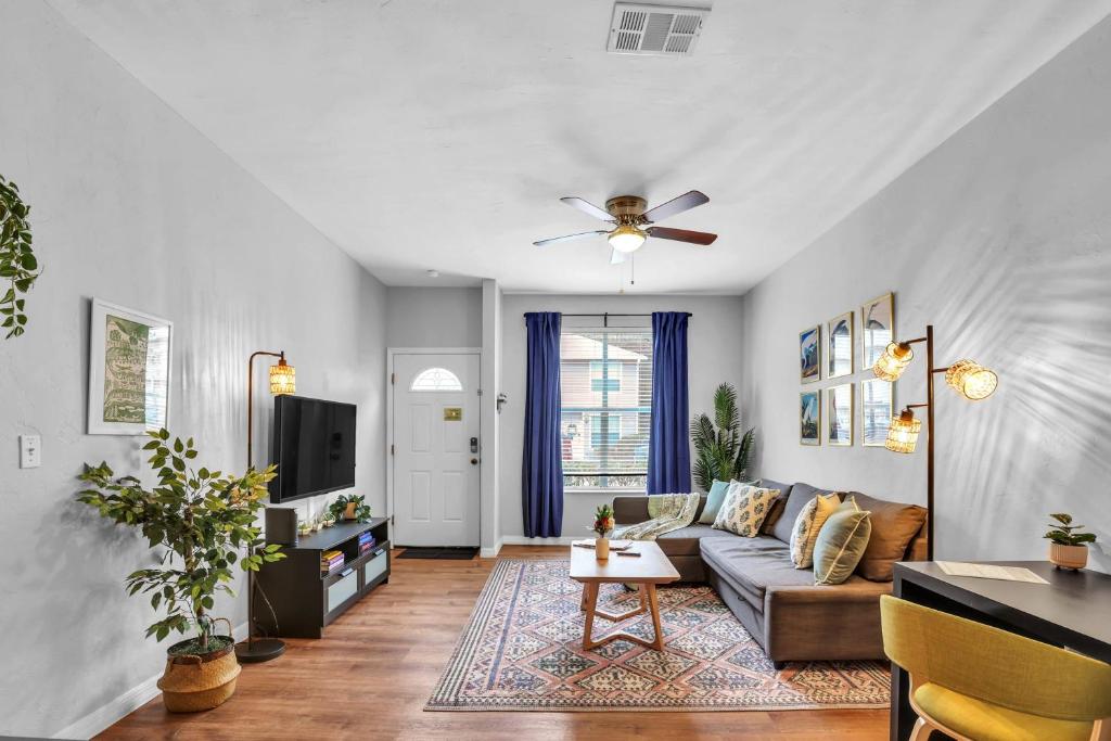 a living room with a couch and a tv at Blissful Haven - Updated & Fully Equipped Condo in Gainesville