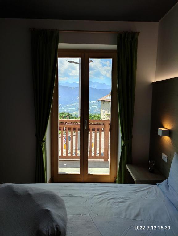 Postel nebo postele na pokoji v ubytování Hotel Villa Argentina Ronzone