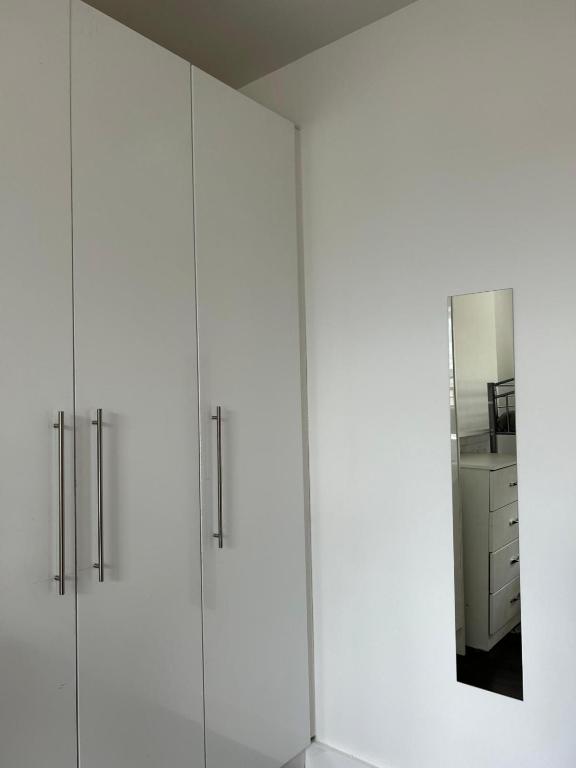 a row of white cabinets in a room at Sarsfields Communities in Dolphinʼs Barn