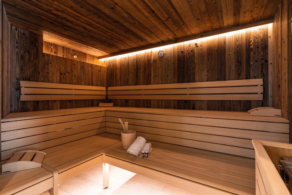 a sauna with wooden walls and wooden floors at Spa Apartments - next to AreitXpress Gondola in Zell am See