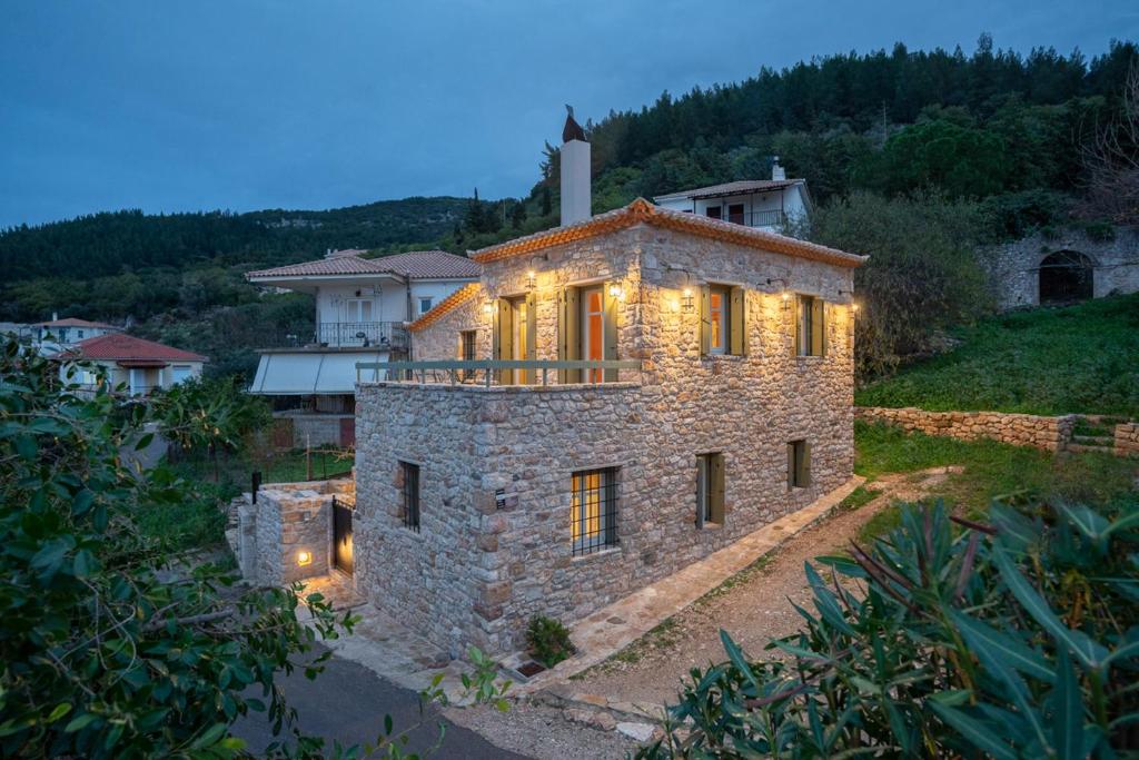 a stone house with lights on top of it at Aries, Marvelous 2floors Maisonette Old Town of Kyparissia in Míloi