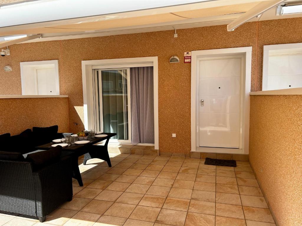 a living room with a table and chairs and a door at Sunny Stay in Torre De La Horadada in Torre de la Horadada
