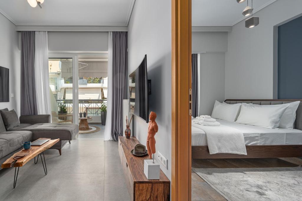 a bedroom with a bed and a living room at Luxurious Coastal Retreat in Central Glyfada in Athens